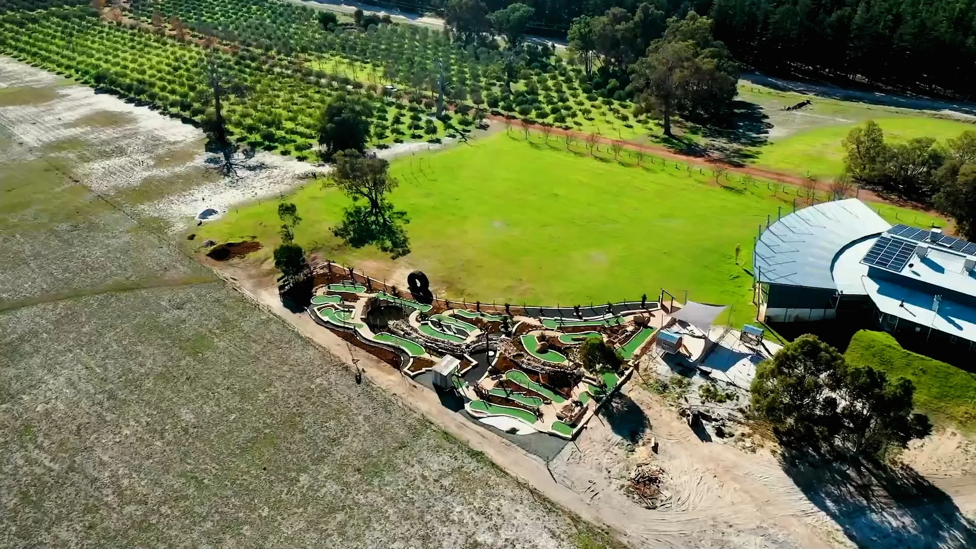 The brewery, recreation lawn, mini-golf course and surrounding olive grove from above.