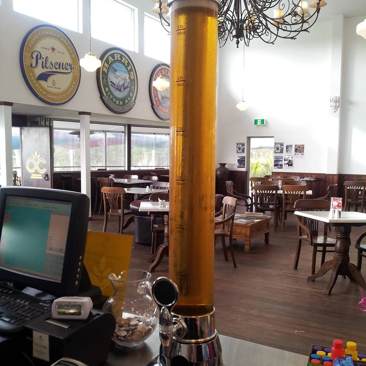Tables, timber flooring and a chandelier in the brewery restaurant.