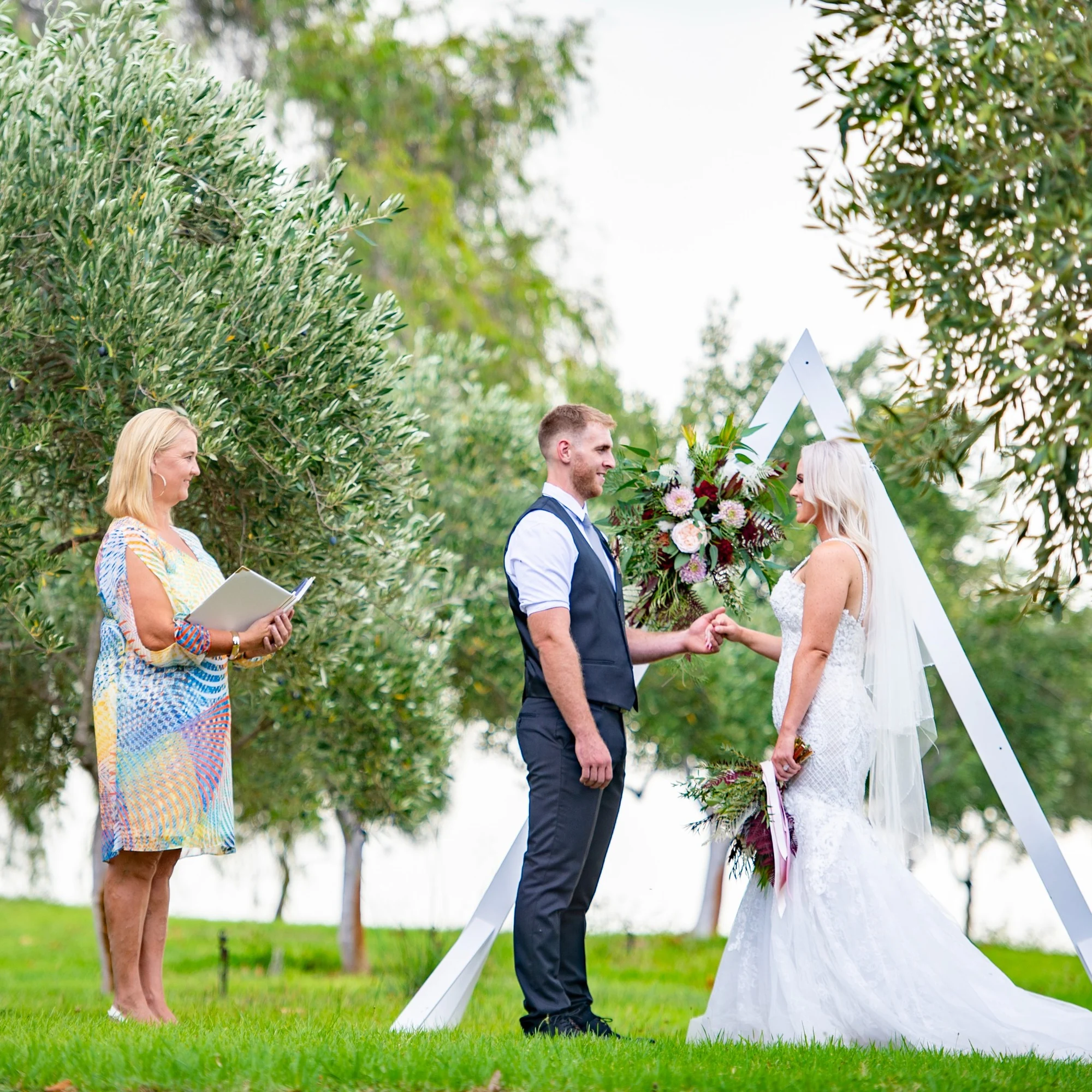 A wedding ceremony in the leafy gardens at Old Coast Road Brewery