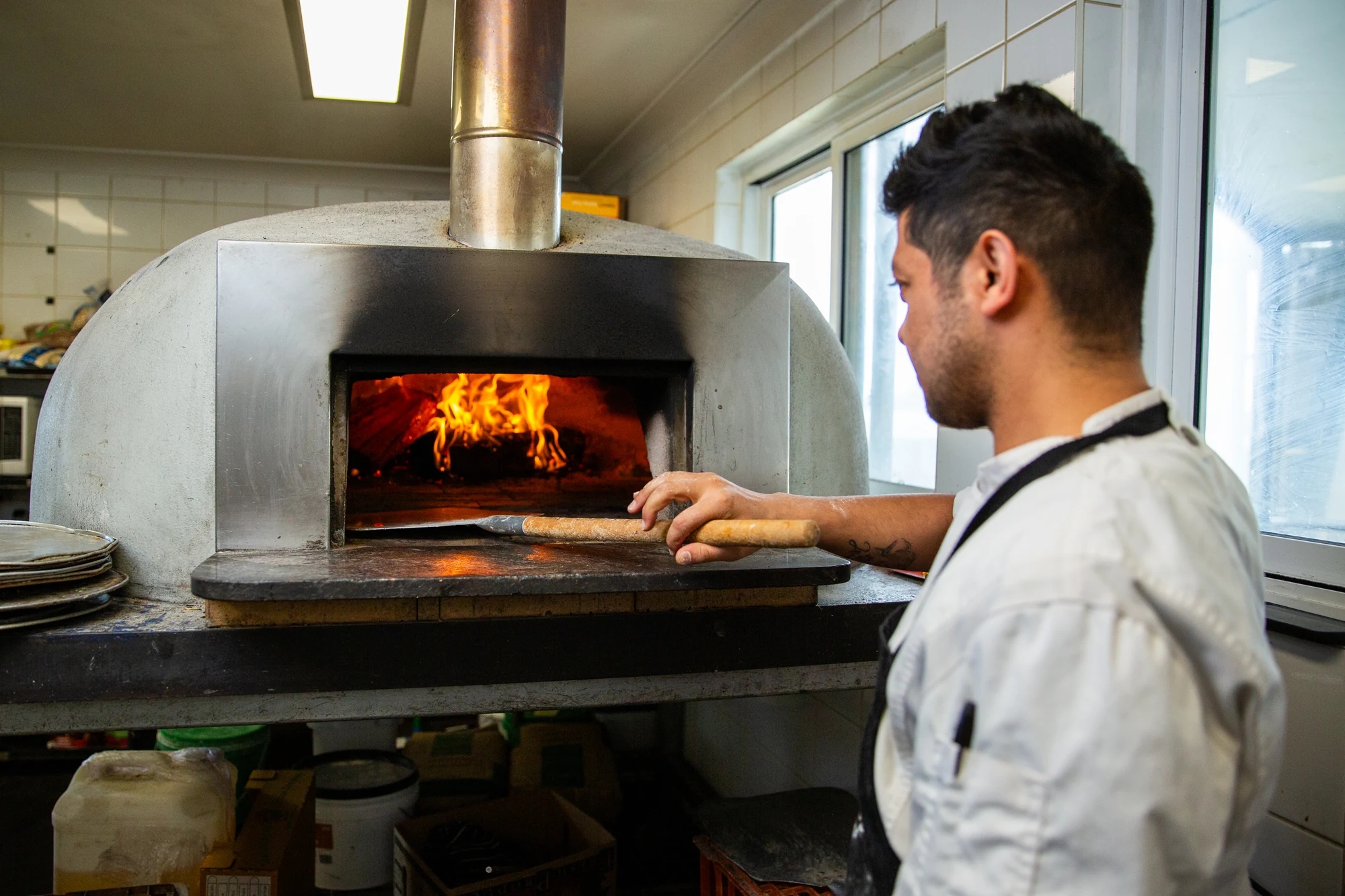 Live cooking beside the woodfired pizza oven at Old Coast Road