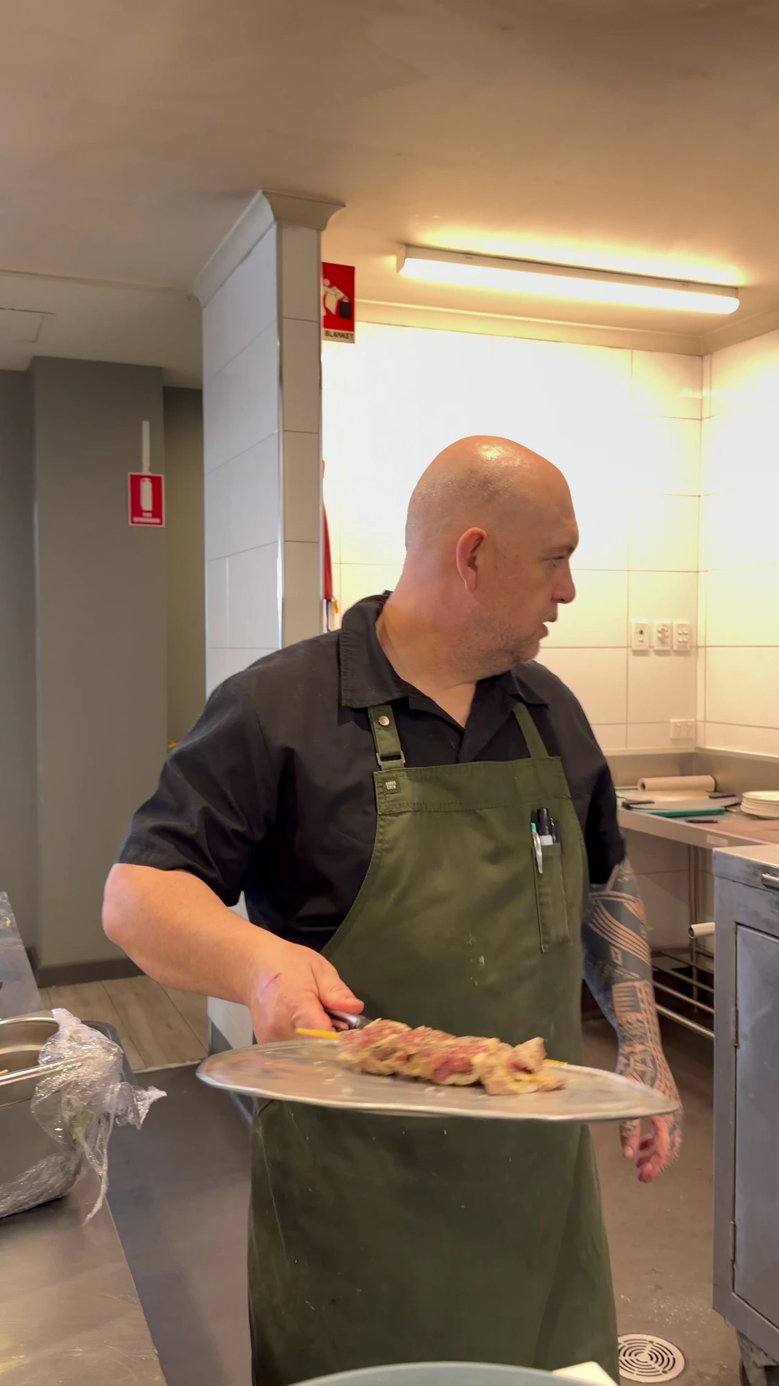 Karl Wulf plating food in the kitchen, from his chef profile film
