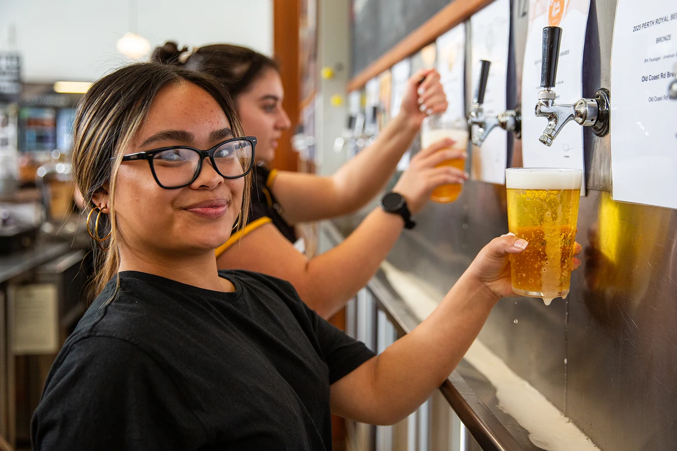 Old Coast Road front-of-house team members pouring beers at the bar