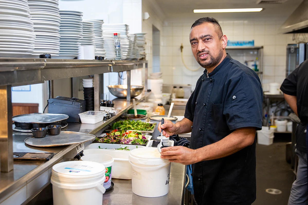 An Old Coast Road kitchen team member preparing food