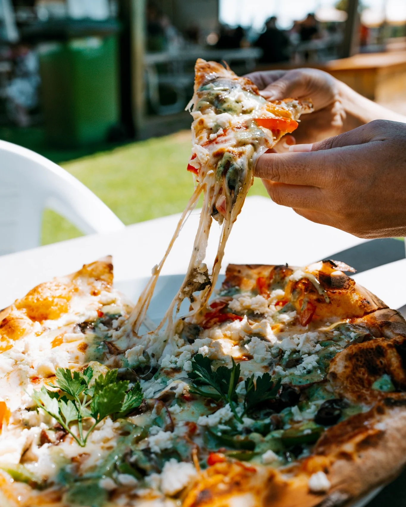 A freshly made Old Coast Road pizza being shared at the table