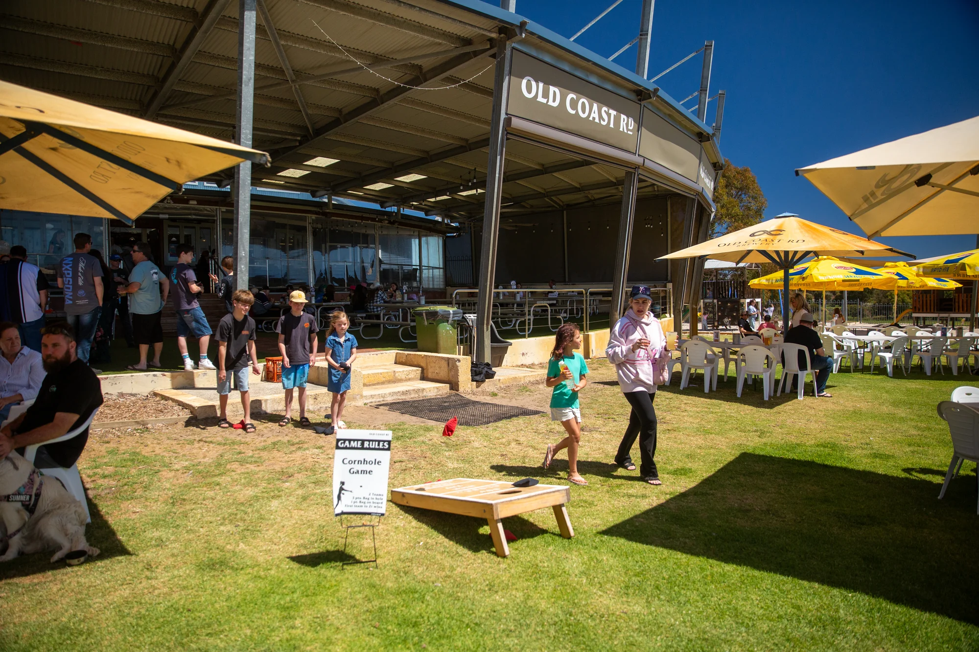 Children playing lawn games in the sunshine outside the brewery