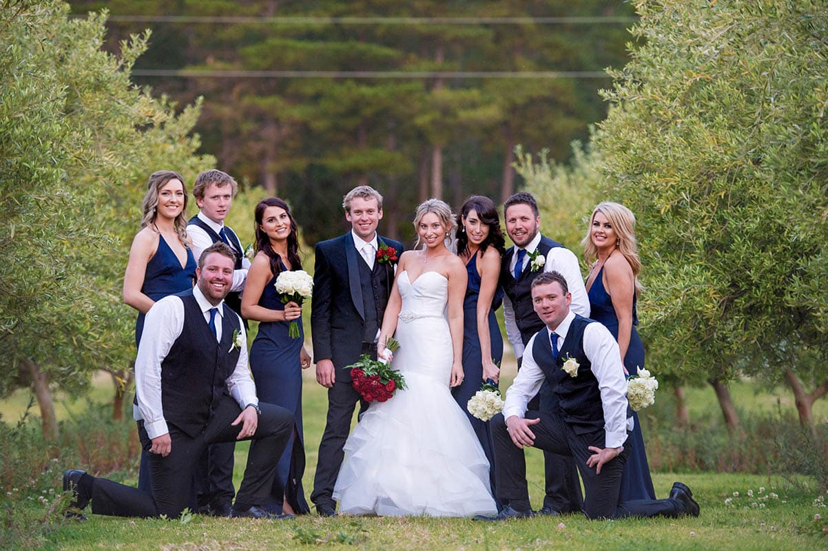 Couple celebrating a rustic outdoor wedding surrounded by scenic bushland and countryside at Old Coast Road Brewery near Bunbury, Western Australia